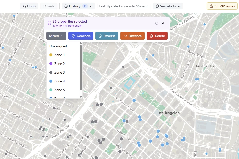 Twenty-six hotels selected on the map, with the zone list open beside Geocode, Reverse, Distance and Delete