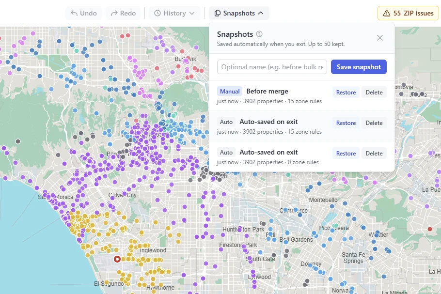 The Snapshots panel over a zoned Los Angeles map: one named checkpoint and two versions saved automatically on exit, each with Restore
